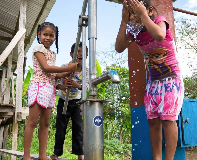 Children in The Amazon Splashing Water from Local Tap Stand_converted